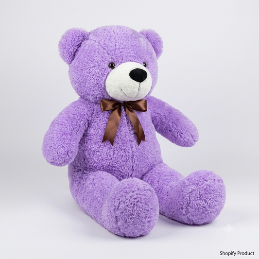A purple plush teddy bear with a white snout and black nose, wearing a brown ribbon bow around its neck, sitting against a light gray studio background.
