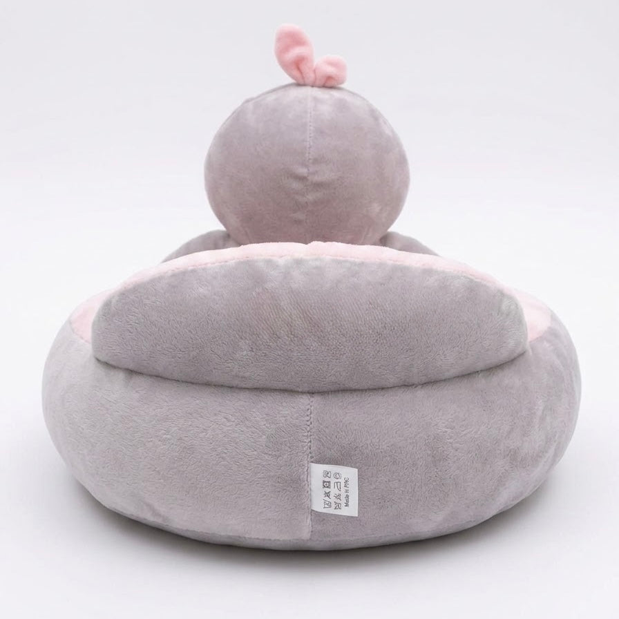 A plush baby pet bed shaped like a duck, featuring a soft gray body with a pink inner lining and a small pink bow on top, shown against a plain white background.