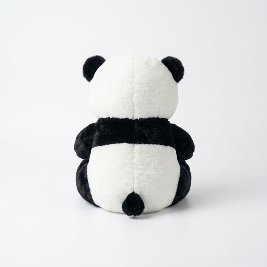 A black and white plush panda toy shown from the back, sitting upright against a clean white studio background.
