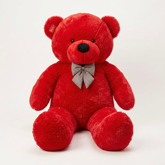 A red plush teddy bear sitting upright against a plain light background, with a small black nose, black eyes, and a black-and-white checkered bow tie at the neck.