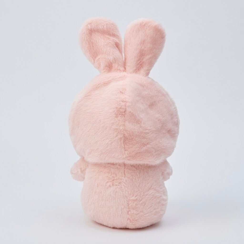 A light pink plush bunny toy shown from the back, featuring soft, fuzzy texture and upright ears, set against a clean white studio background.