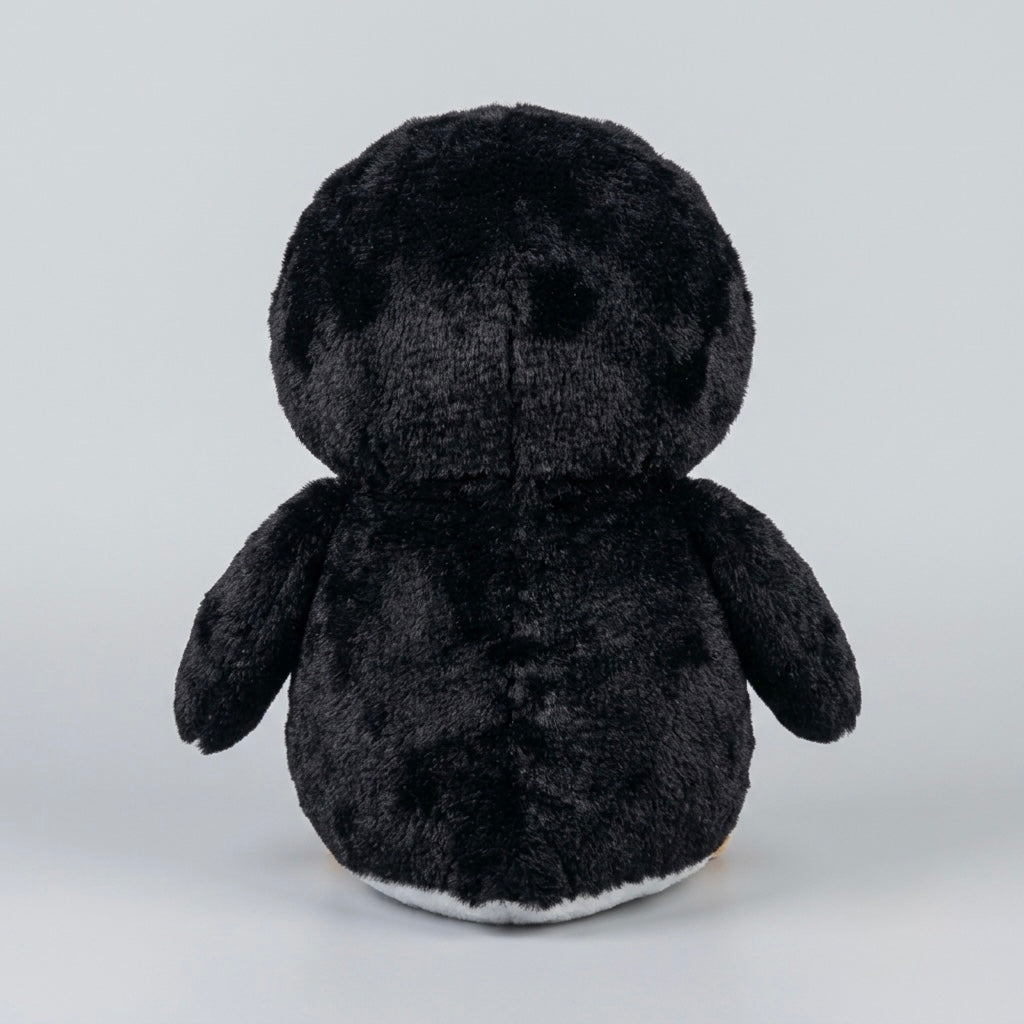 A black plush penguin toy shown from the back, featuring a soft, fuzzy texture and a small white underside, set against a plain light gray background.
