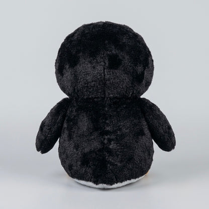 A black plush penguin toy shown from the back, featuring a soft, fuzzy texture and a small white underside, set against a plain light gray background.