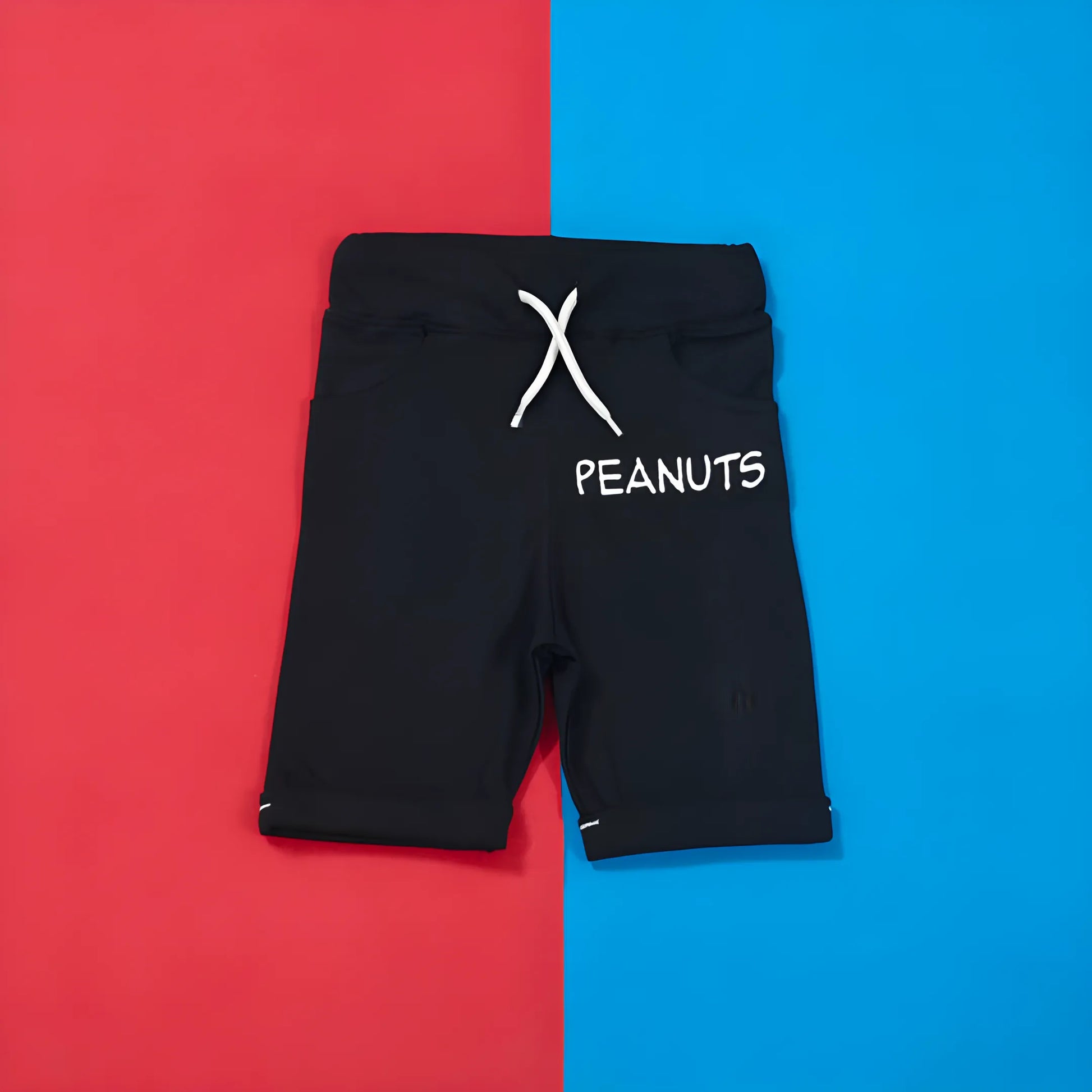 Black shorts with 'Peanuts' logo on a red and blue background