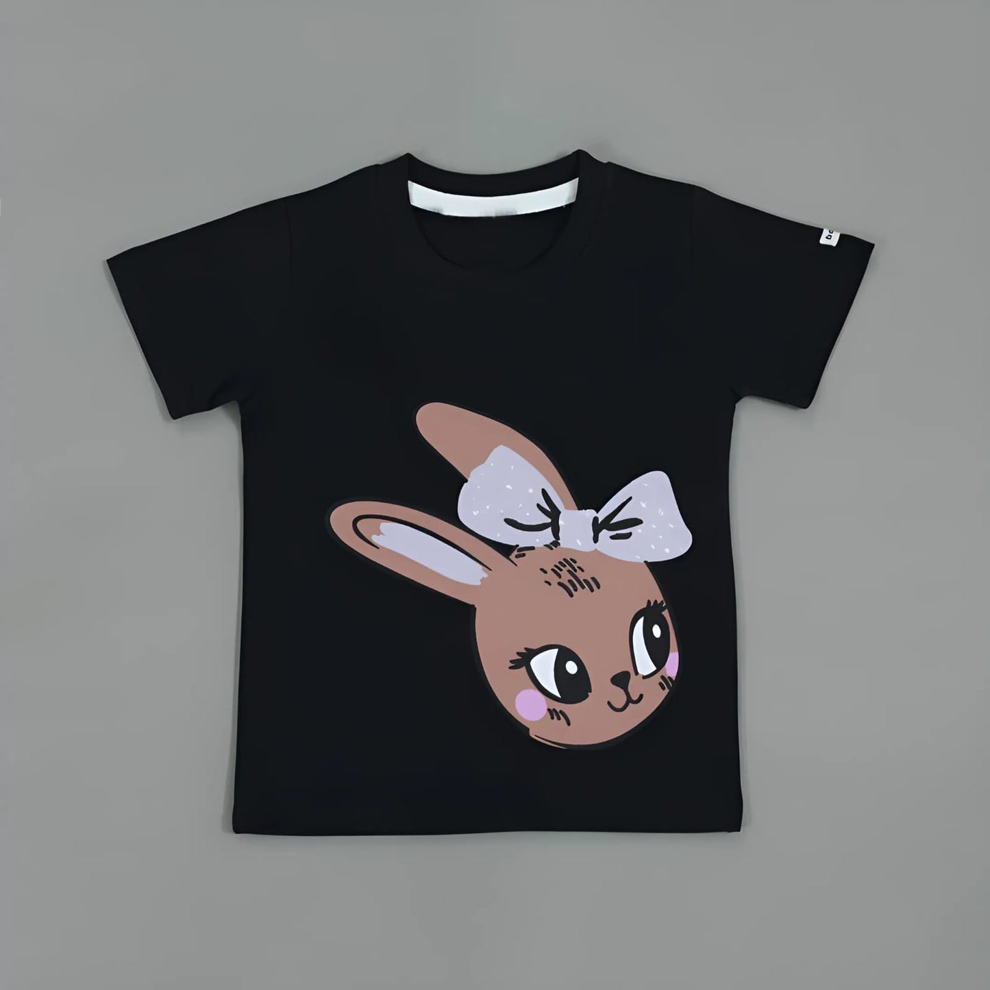 Black t-shirt with a cartoon bunny design on a gray background