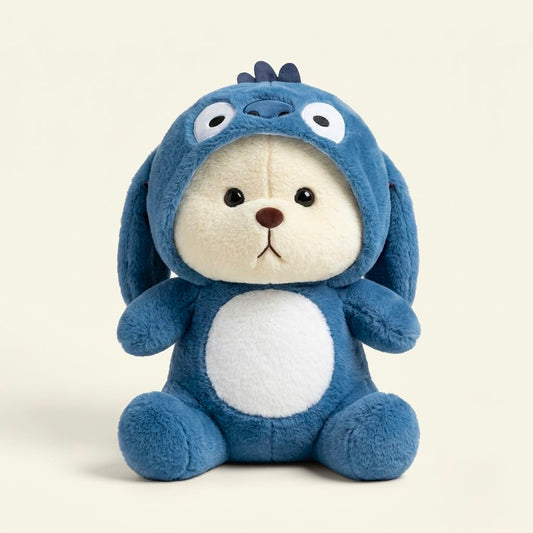 A plush toy shaped like a blue bunny dog wearing a hooded bunny suit, sitting against a plain light beige background.