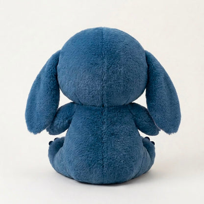 A blue plush toy with long floppy ears, shown from the back against a plain off-white background.