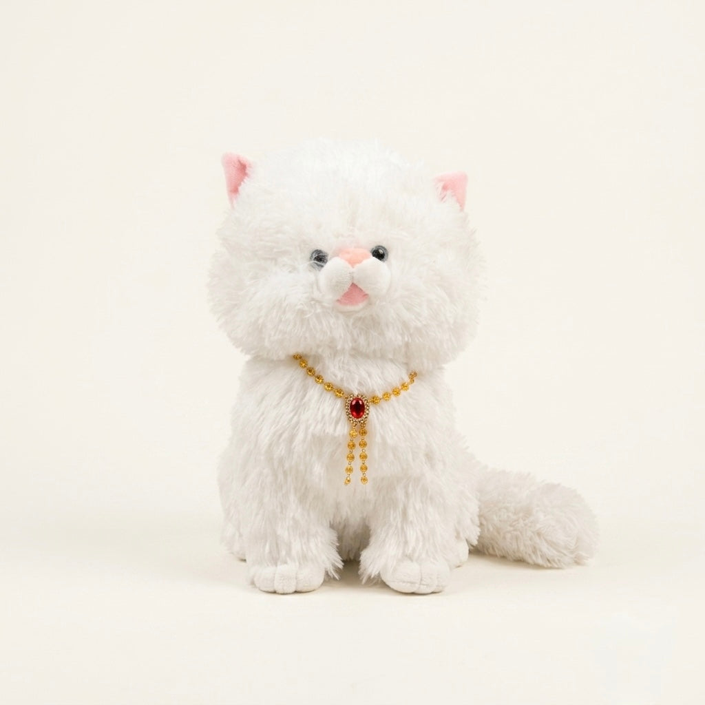 A white fluffy plush kitten toy with pink inner ears, a pink nose, black bead eyes, and a gold beaded collar with a red jewel, sitting against a plain cream background.
