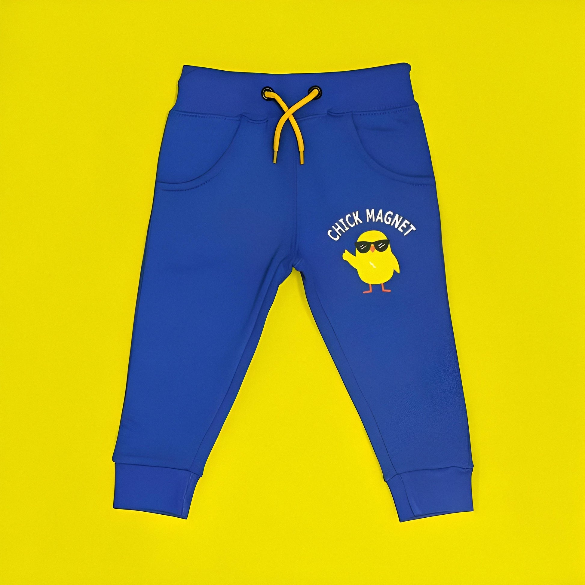 Blue children's jogger pants with a yellow chick graphic and 'Chick Magnet' text on a yellow background