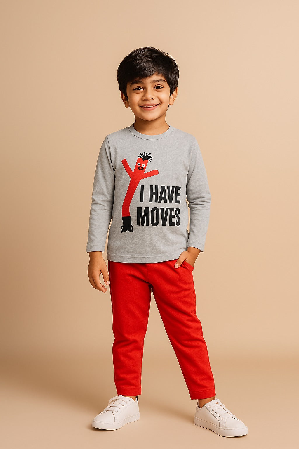 Child wearing a gray shirt with 'I Have Moves' text and red pants on a beige background