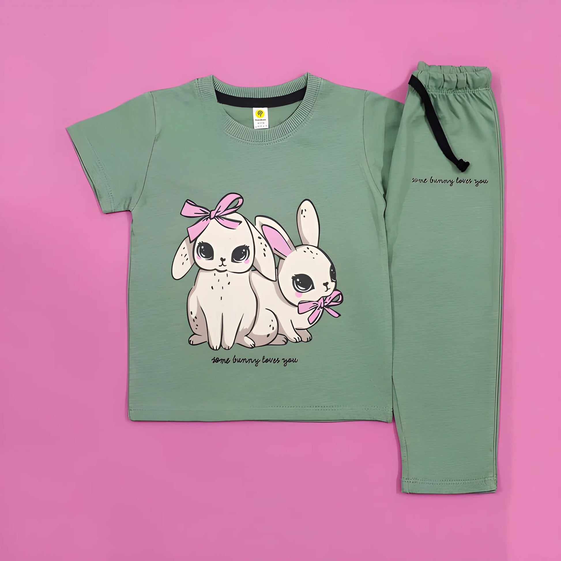 Children's pajama set with cartoon bunnies on a pink background