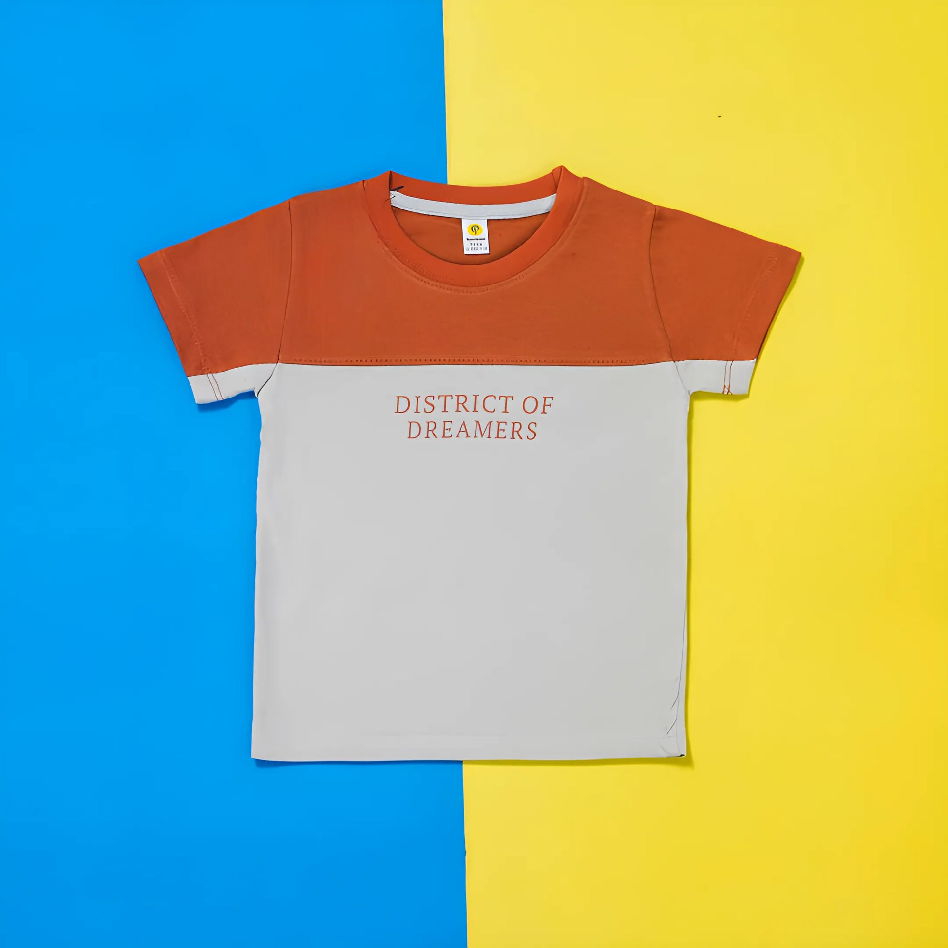 Children's t-shirt with 'District of Dreamers' text on a blue and yellow background