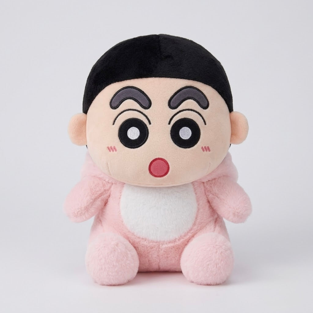 A plush toy character with a black hair bun, large cartoon eyes, and a pink outfit with a white belly patch, photographed against a light gray studio background.
