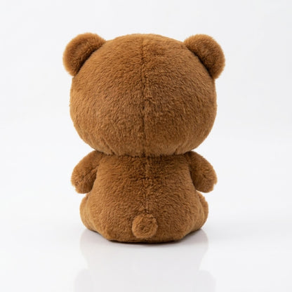 A brown plush teddy bear toy shown from the back, sitting on a clean white reflective surface.