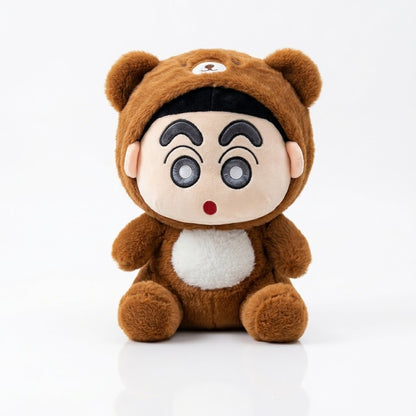 A plush toy doll dressed in a brown bear costume, featuring a round beige face with large cartoon eyes, a small red nose, and a white belly patch, photographed on a clean white background.