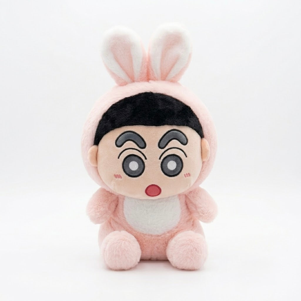 A plush toy character wearing a pink bunny costume, featuring large cartoon eyes, a surprised expression, and a black hair section, set against a plain white background.