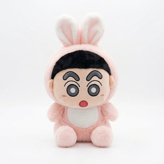 A plush toy character wearing a pink bunny costume, featuring large cartoon eyes, a surprised expression, and a black hair section, set against a plain white background.