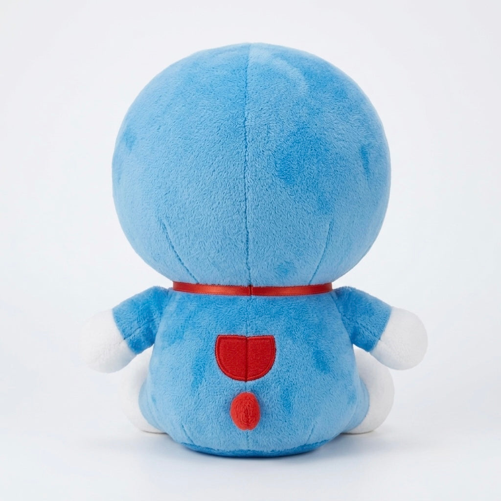 A blue plush toy shown from the back, featuring a round head, white hands and feet, a red collar, and red back details, photographed against a clean white background.