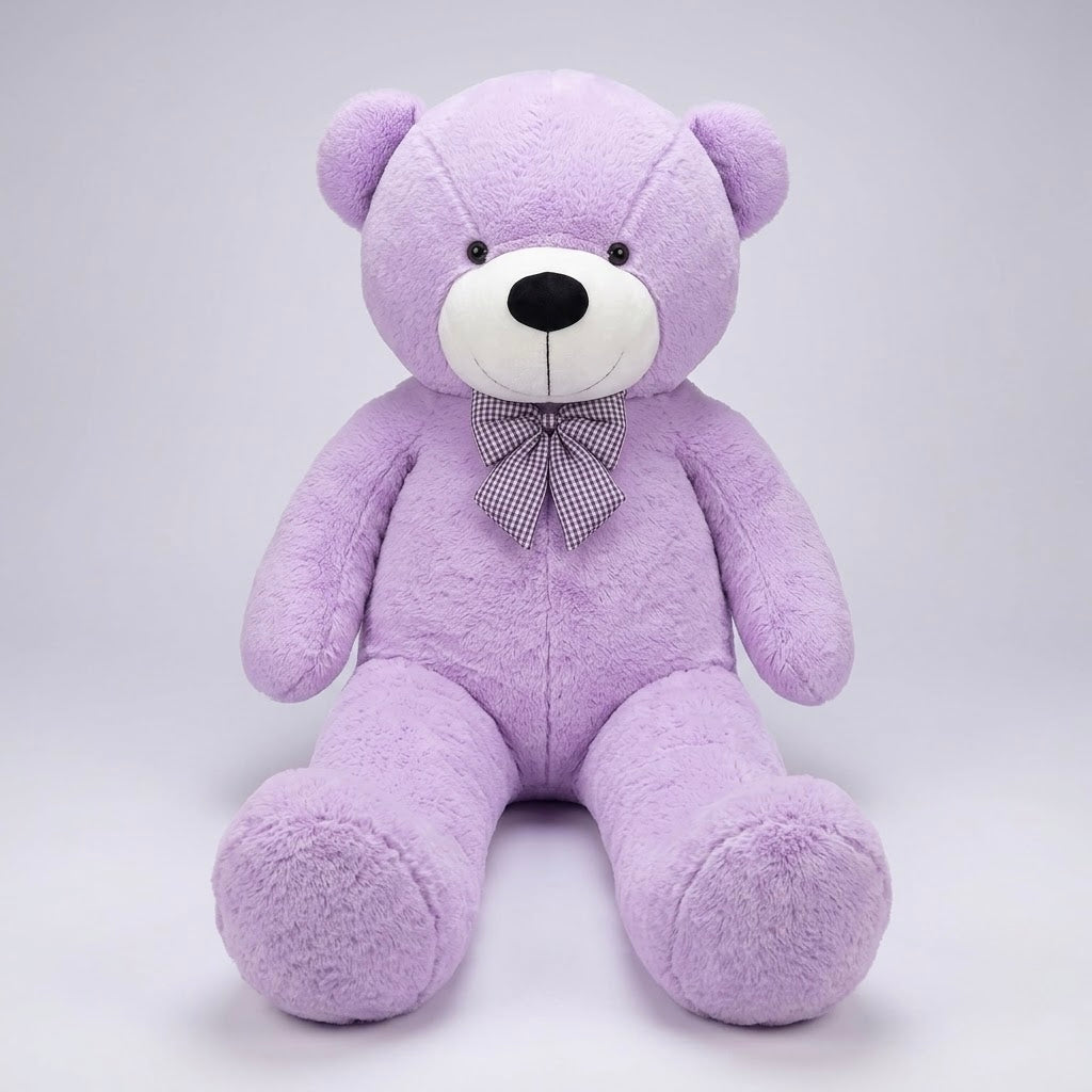 A plush purple teddy bear sitting upright against a light gray studio background. The bear has a white snout, small black eyes and nose, and a purple-and-white checkered bow tie.