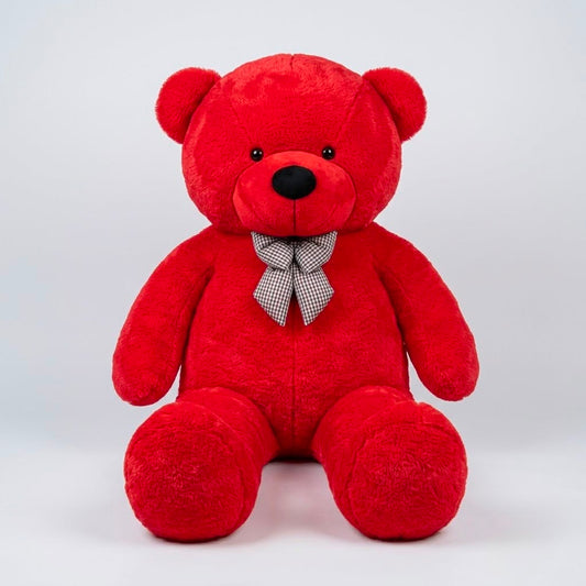 Giant 7 feet life-size red plush teddy bear with checkered bow tie sitting upright on clean white studio background