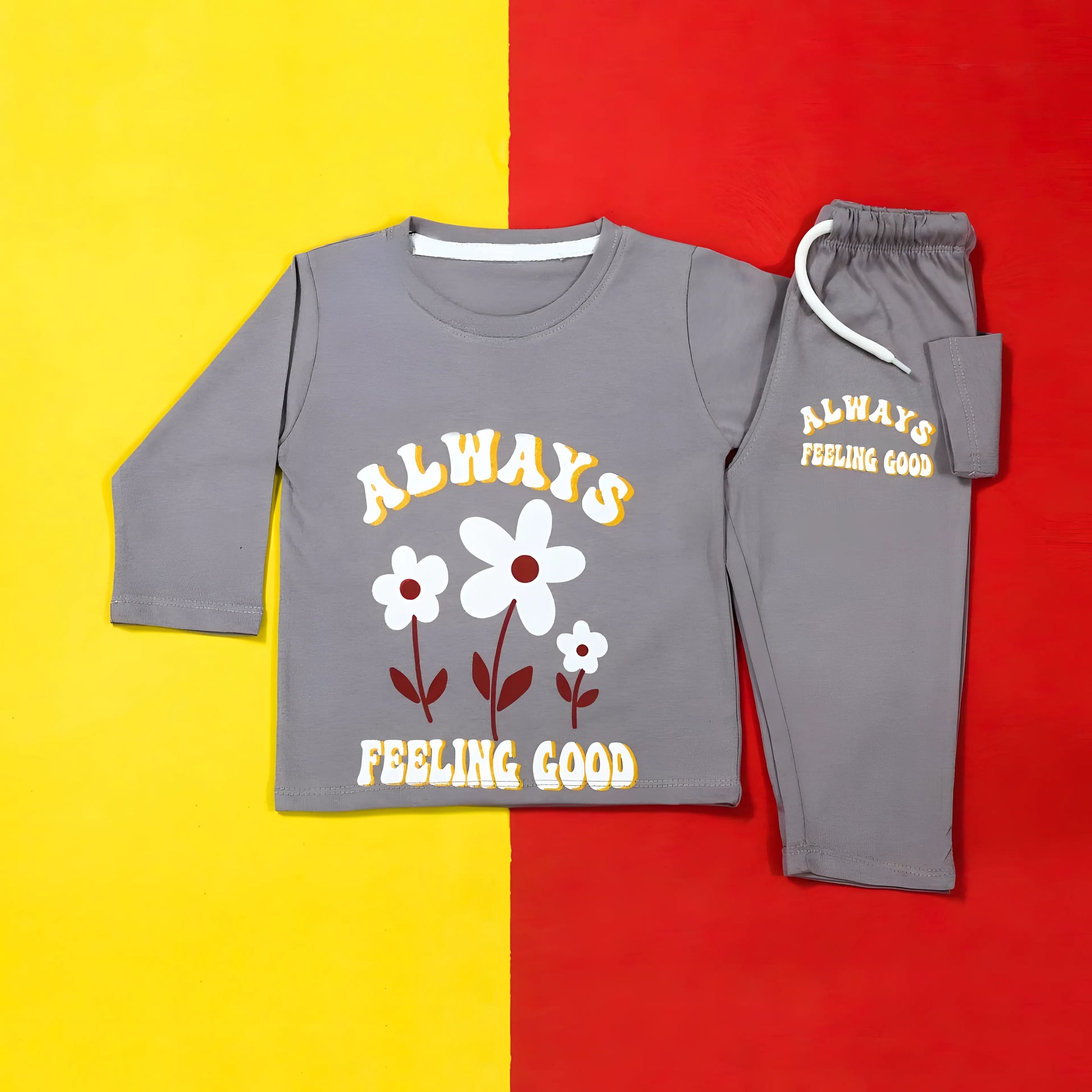 Gray children's pajama set with floral design and text on a yellow and red background