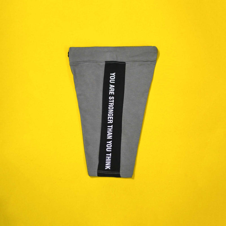 Gray pouch with motivational text on a yellow background