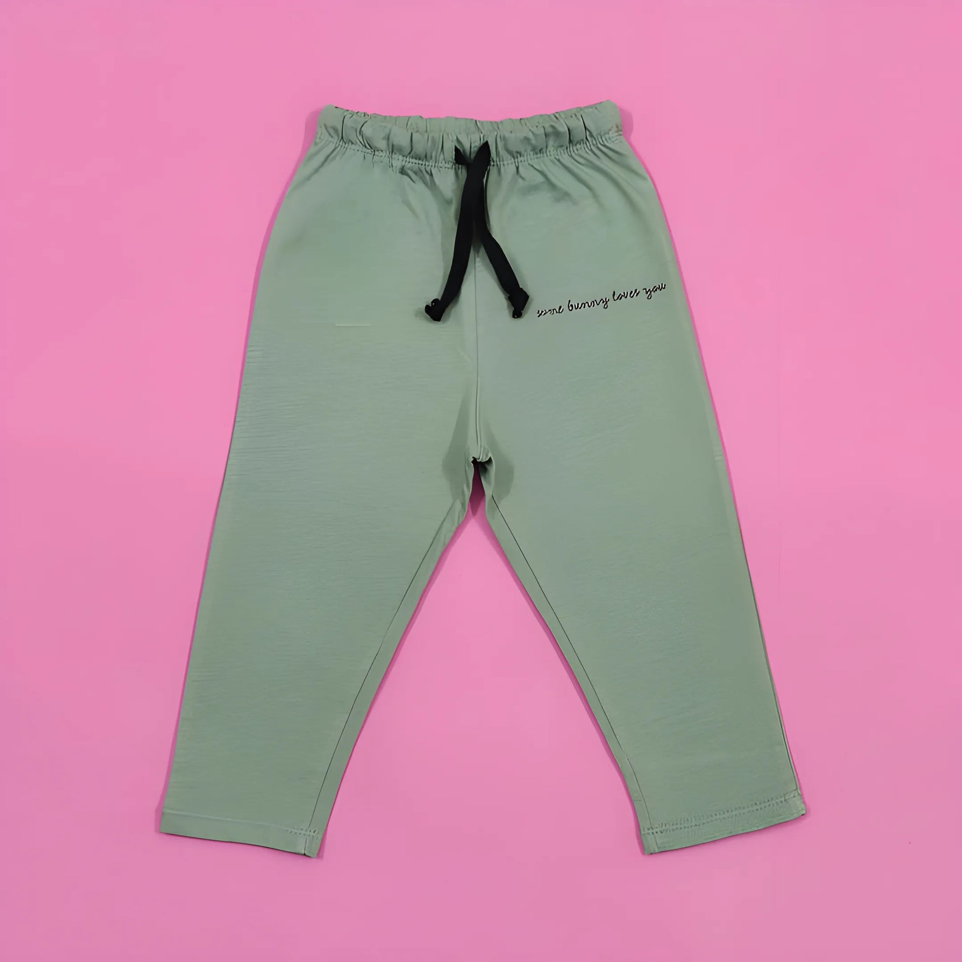 Green pants with text on a pink background