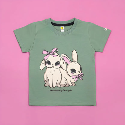 Green t-shirt with cartoon bunnies and text on a pink background