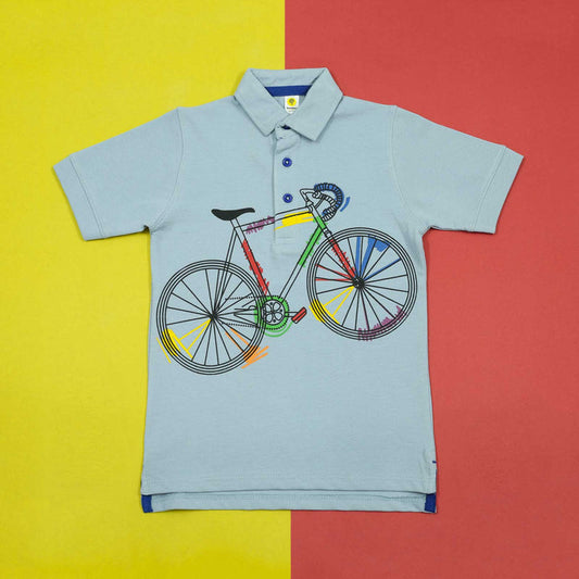 Light blue polo shirt with a colorful bicycle design on a yellow and red background
