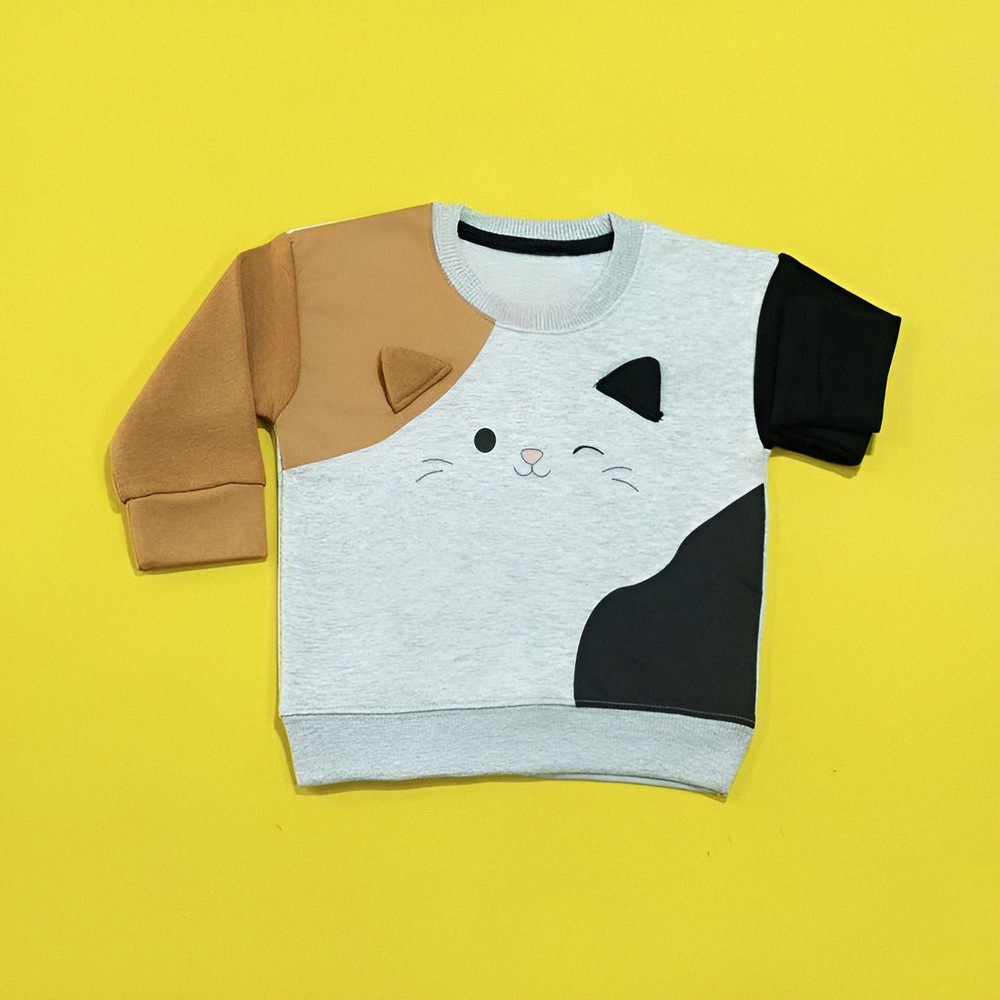 Children's sweater with cat design on a yellow background