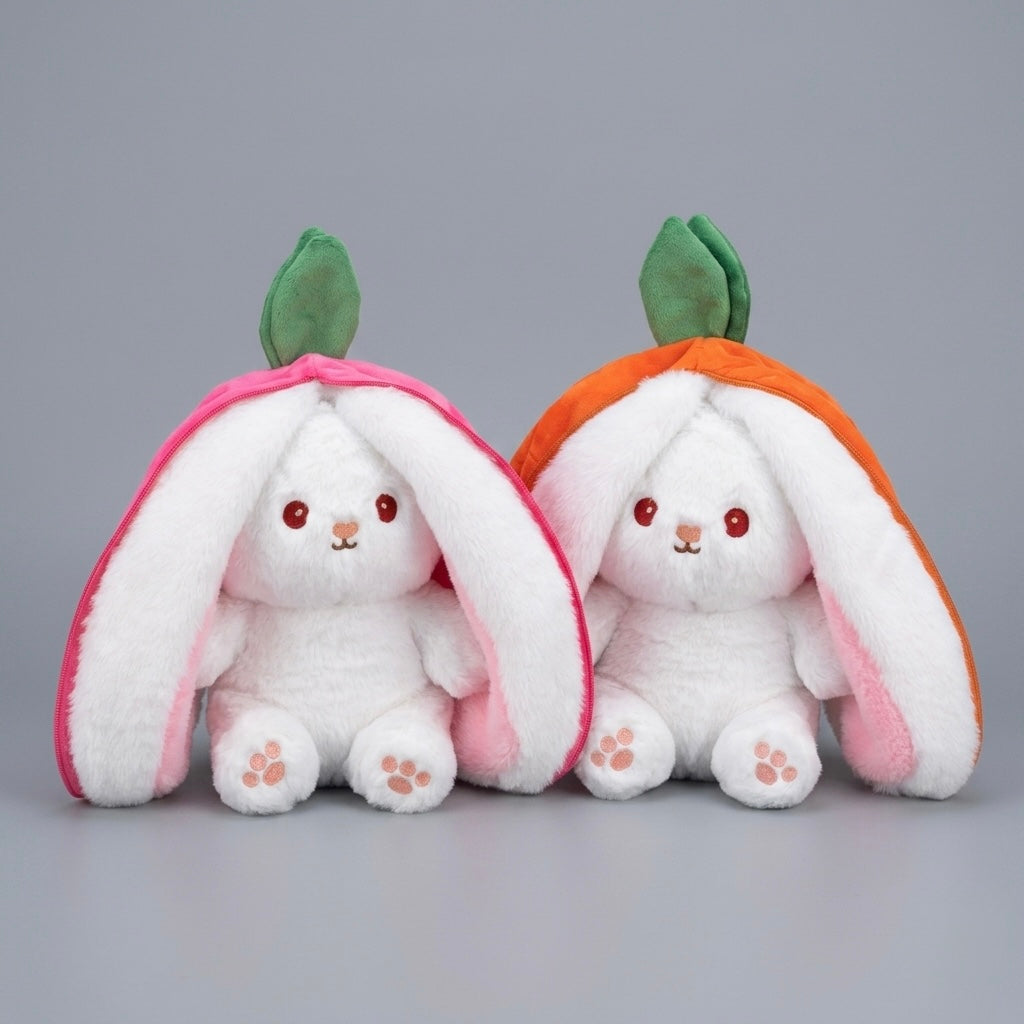 Two plush bunny toys sitting side by side, each wearing a mushroom-shaped hood. The left bunny wears a pink mushroom hood, and the right bunny wears an orange mushroom hood.