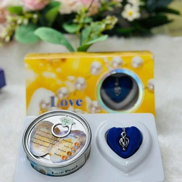 Pearl necklace set with a tin and heart-shaped box on a floral background