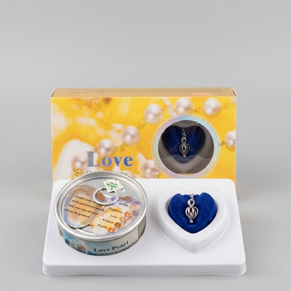 Love Pearl jewelry gift set featuring a silver-toned pendant charm, a round tin canister, and a blue heart-shaped presentation box, displayed in front of its yellow and white packaging box.