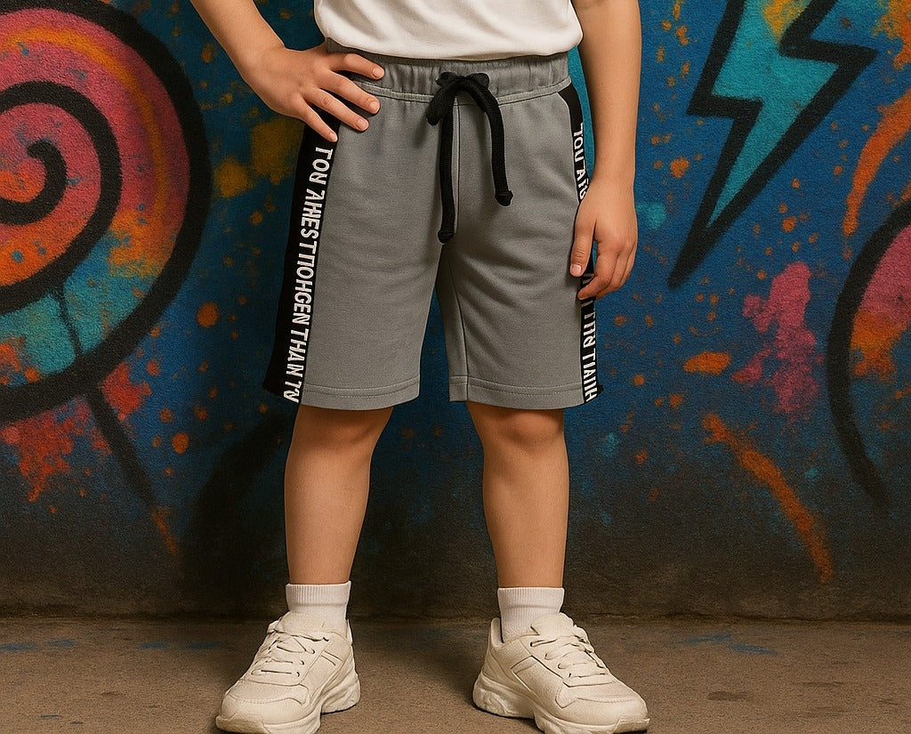 Person wearing gray shorts with text against a colorful graffiti wall.