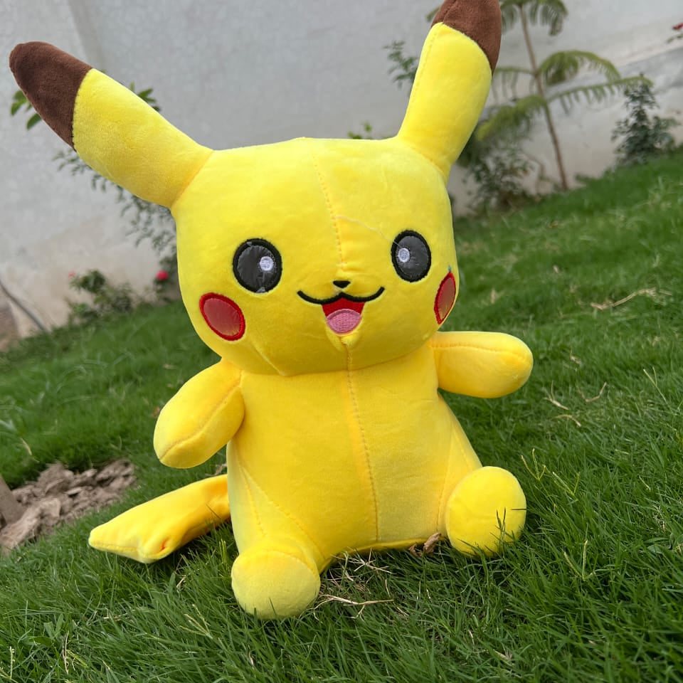 Plush toy resembling Pikachu on grass