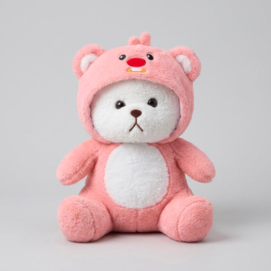 A pink plush teddy bear wearing a white bear-face hood, sitting against a plain light gray studio background.