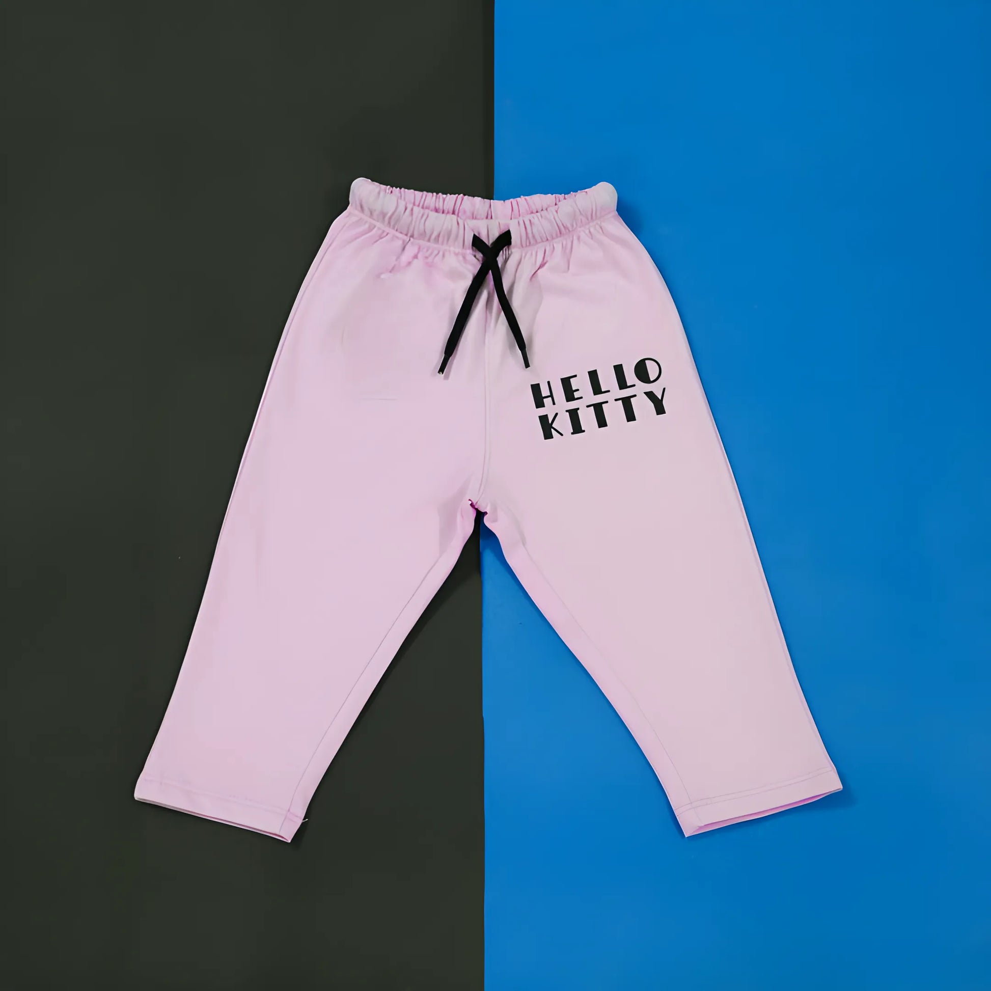 Pink 'Hello Kitty' pants on a black and blue background