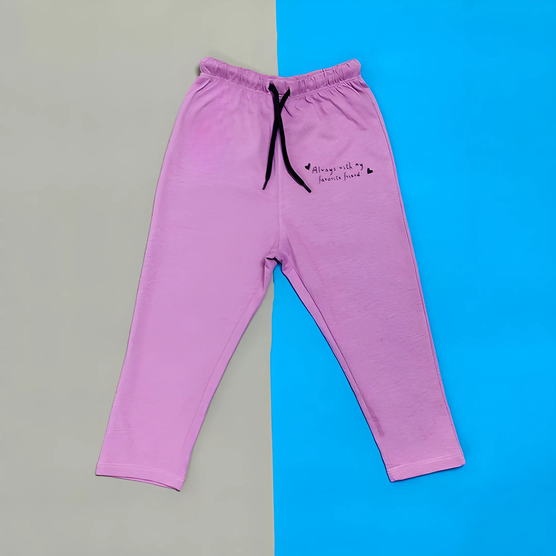 Pink sweatpants with text on a gray and blue background