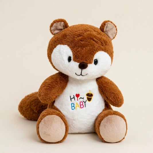 A brown and white plush squirrel toy sitting upright against a light beige background. The chest features embroidered text reading 'H O [heart] BABY' with small colorful accents.
