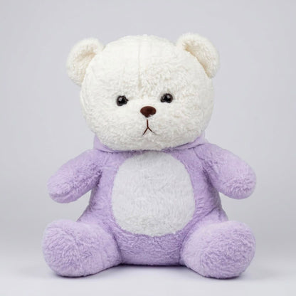 A plush teddy bear with a white fluffy head and face, a light purple body, and a white circular patch on the chest, sitting against a light gray background.