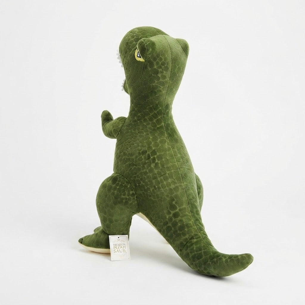 A green plush dinosaur toy with a textured scale pattern, standing on a white background with a small tag attached.