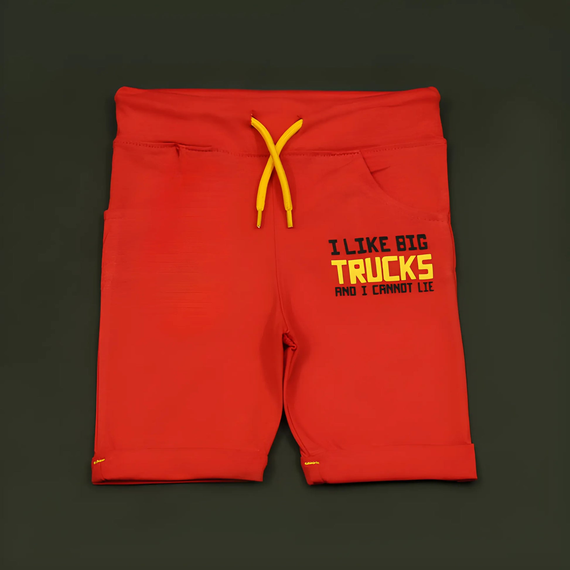 Red shorts with yellow text and drawstring on a dark background