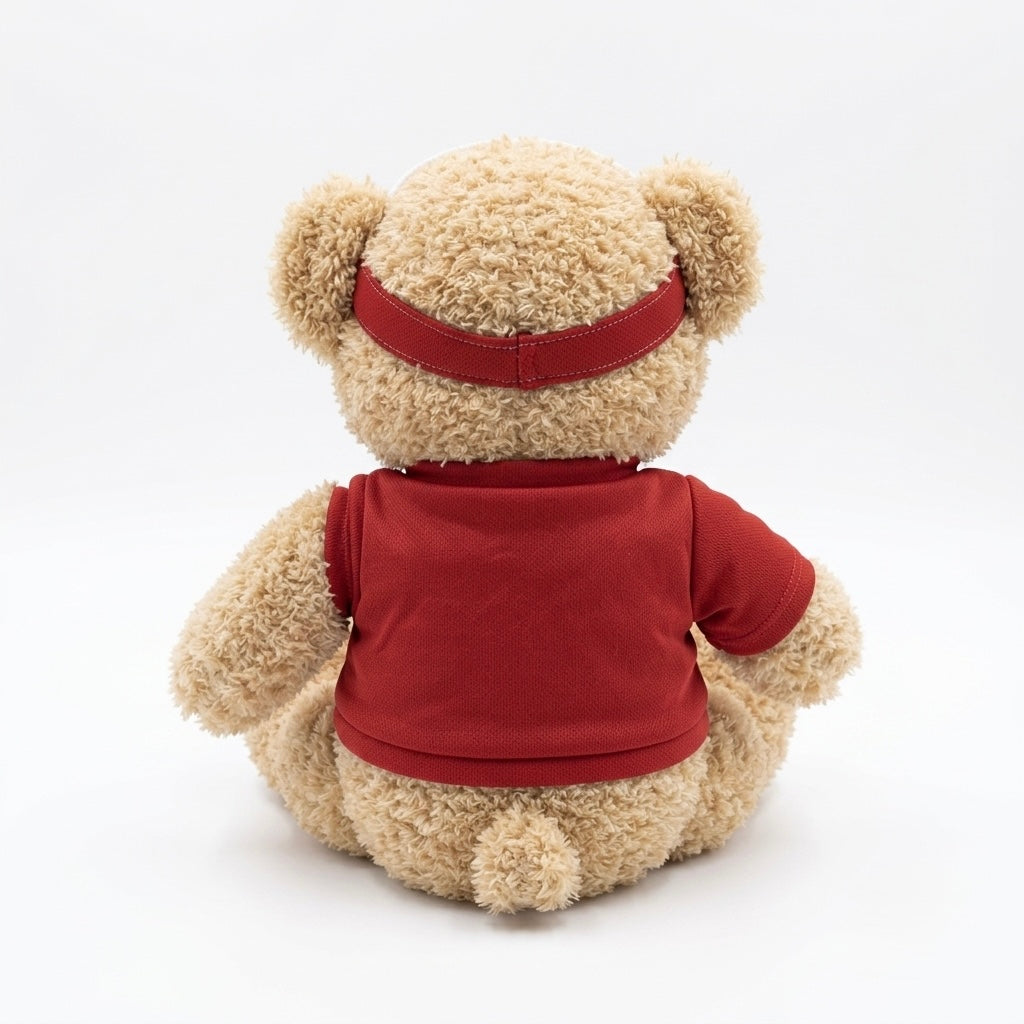 A beige teddy bear plush toy shown from the back, wearing a red short-sleeve shirt and a matching red headband, photographed on a clean white background.