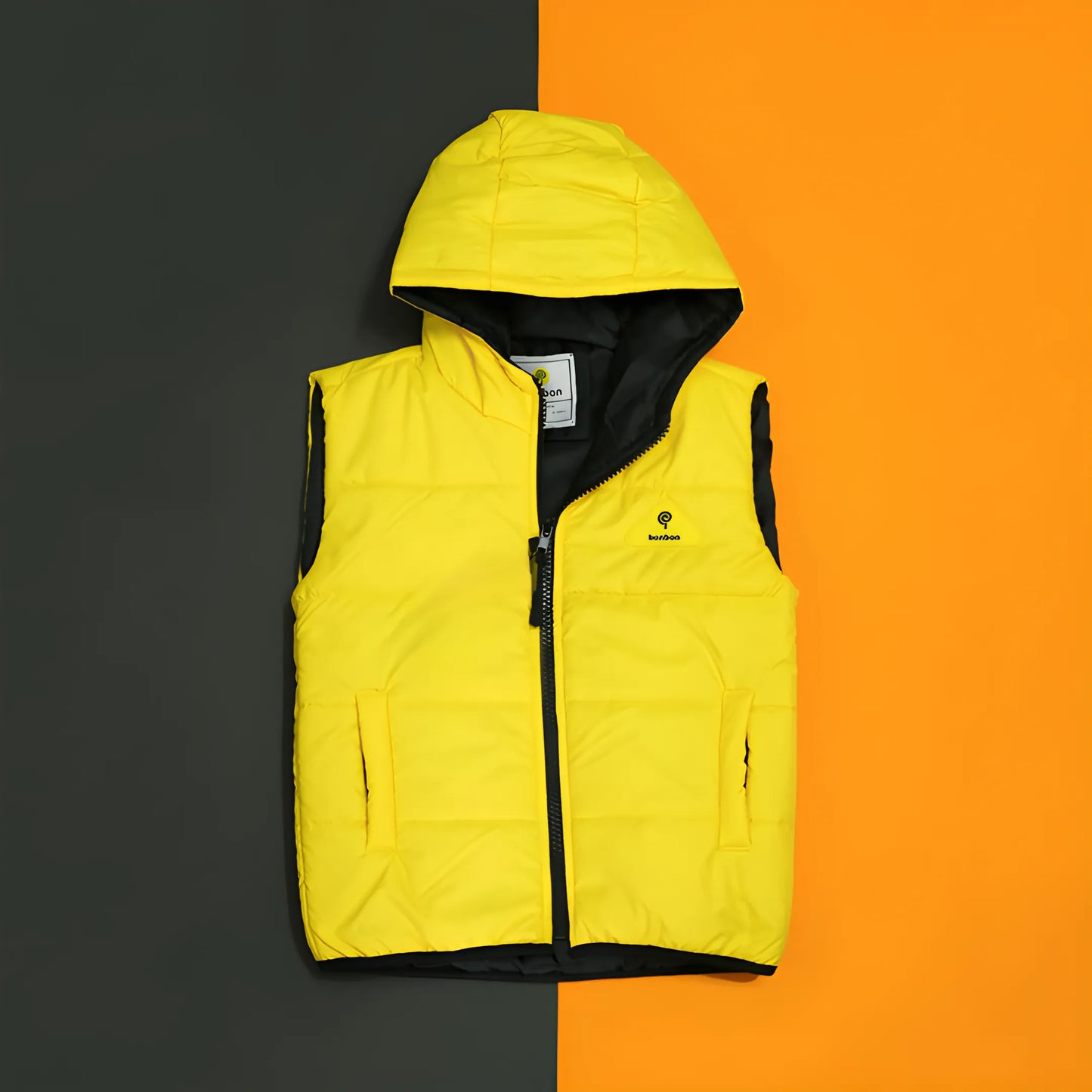 Yellow puffer vest with a brand logo on an orange and black background