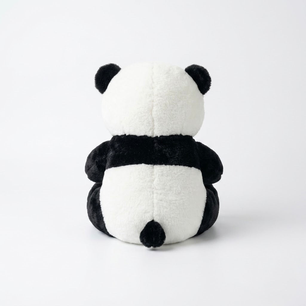 A black and white plush panda toy shown from the back, sitting upright against a clean white studio background.
