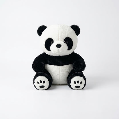 Front view of a soft black and white plush panda bear sitting against a clean white background