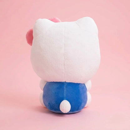 A plush toy shown from the back, featuring a large white head with pink inner ears, a blue body, and a small white tail, set against a solid pink background.